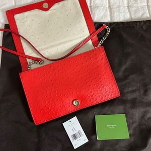 Red Kate Spade convertible clutch with gold & red leather shoulder chain.